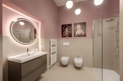 a bathroom with a sink and a toilet and a mirror at Arte Apartments in Bolzano