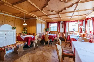 a restaurant with tables and chairs in a room at Residence Speckerhof in Maranza