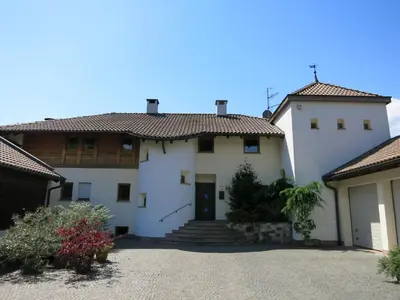 a large white house with a driveway at Feldererhof in Postal