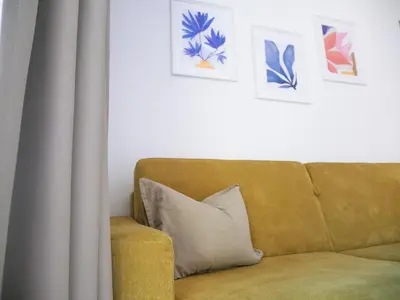 a couch with a pillow and some pictures on the wall at Appartement Baumgärtner in Naturno