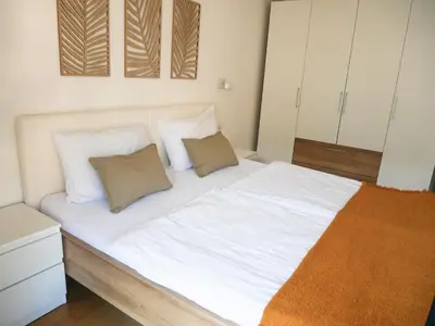 a bedroom with a bed with white sheets and pillows at Appartement Baumgärtner in Naturno