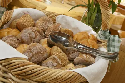 a basket filled with different types of donuts and pastries at Garni-Hotel Tritscherhof in Tirolo