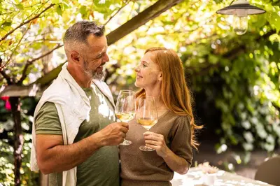 a man and a woman holding glasses of wine at Parkhotel Tirolerhof in Lagundo