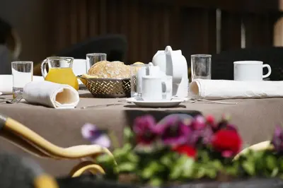 a table with a table cloth with flowers on it at Parkhotel Tirolerhof in Lagundo