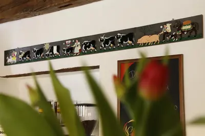 a picture of animals on a wall with a plant at Parkhotel Tirolerhof in Lagundo