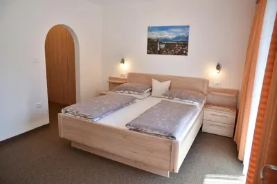 a bedroom with two beds and a painting on the wall at Ferienwohnungen Burgwies in San Martino