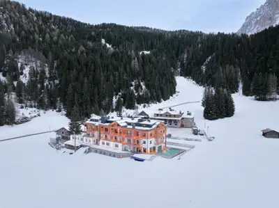 an aerial view of a house in the snow at Hotel Pozzamanigoni in Selva di Val Gardena