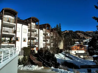 a large building with snow on the ground in front of it at Apartment Sissi in Badia