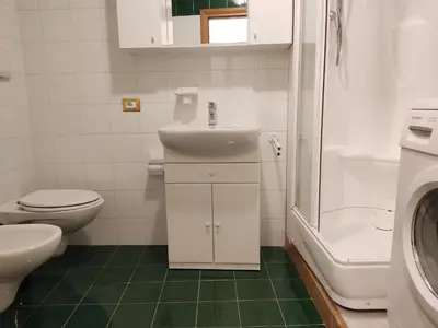 a bathroom with a sink and a toilet and a shower at Apartment Sissi in Badia