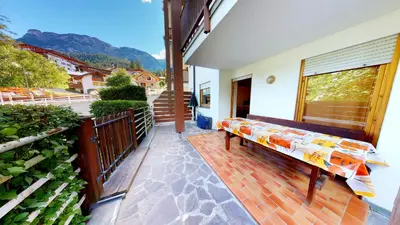 a patio with a bench on a balcony at Apartment Sissi in Badia