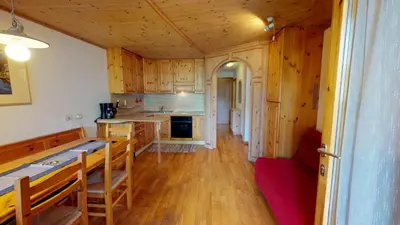 a kitchen with wooden cabinets and a counter top at Apartment Sissi in Badia