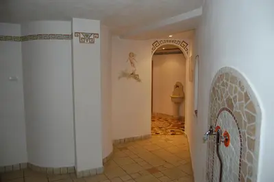 a hallway with a door and a tile floor at Hotel Engel in Canazei