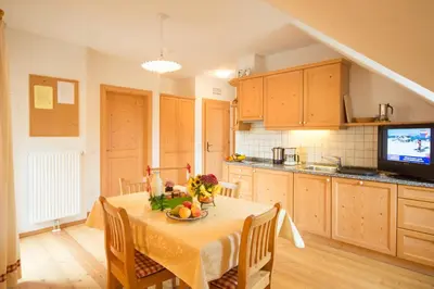 a kitchen with a table with a bowl of fruit on it at Peterer Hof in Rasùn di Sotto