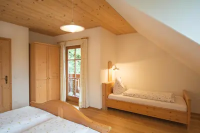 a bedroom with two beds and a window at Peterer Hof in Rasùn di Sotto