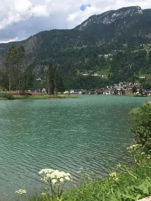 a large body of water with mountains in the background at Monolocale DORI in Alleghe