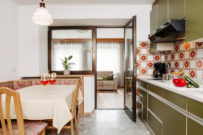 a kitchen with a table and a dining room at Apartm. & BB Ferienidylle Gstrein in Rablà