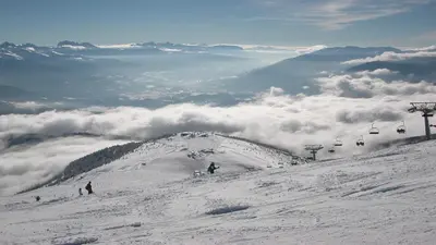 a snow covered mountain with people on a ski lift at Holiday Residence Mesenhaus in Maranza