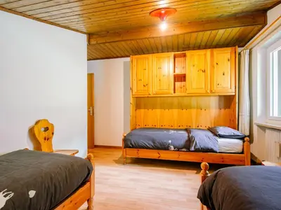 a bedroom with a bed and a wooden ceiling at Apartment Mantina-2 by Interhome in Moena
