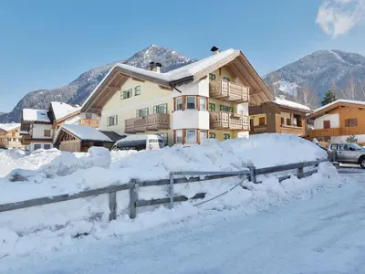 a house covered in snow with a pile of snow at Apartment Maura-2 by Interhome in Pozza di Fassa