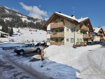 a truck parked in front of a house in the snow at Apartment Maura-2 by Interhome in Pozza di Fassa