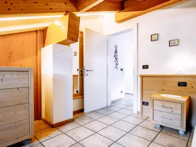 two white beds in a room with a tv at Apartment Carmen-1 by Interhome in Soraga