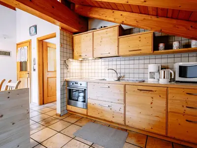 a kitchen with a table and a dining room at Apartment Carmen-1 by Interhome in Soraga