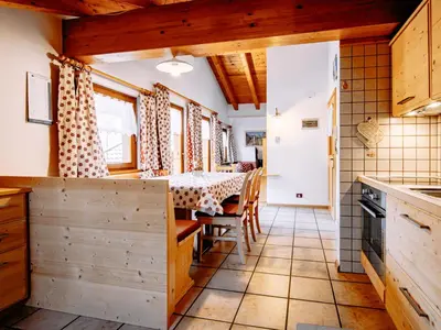 a kitchen with wooden cabinets and a stove at Apartment Carmen-1 by Interhome in Soraga