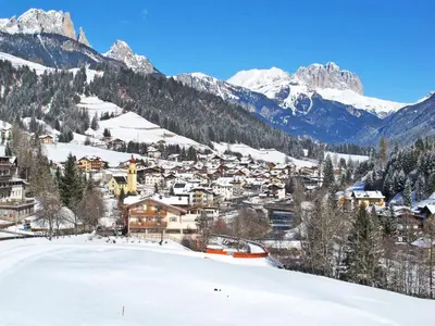 a town in the snow with mountains in the background at Apartment Brunel - SOF773 by Interhome in Soraga