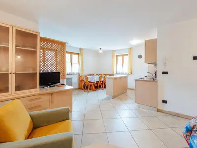 a kitchen and living room with a couch and a table at Apartment Brunel - SOF773 by Interhome in Soraga