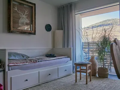 a bedroom with a bed and a sliding glass door at Apartment Laura Brixen Vahrn in Varna