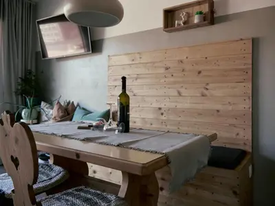 a dining room table with a bottle of wine on it at Apartment Laura Brixen Vahrn in Varna