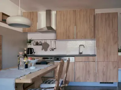 a kitchen with wooden cabinets and a counter top at Apartment Laura Brixen Vahrn in Varna