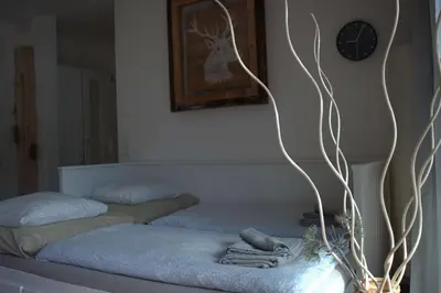 a bedroom with two beds and a clock on the wall at Apartment Laura Brixen Vahrn in Varna