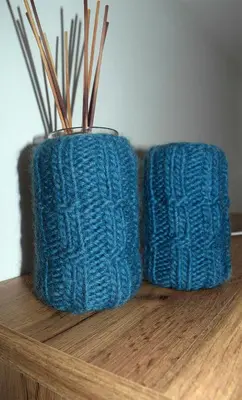two blue knitted vases sitting on a wooden table at Apartment Laura Brixen Vahrn in Varna