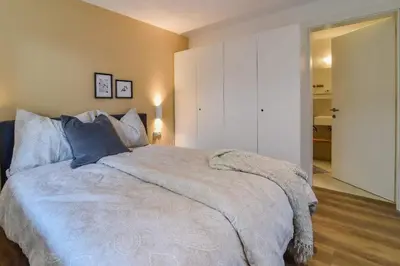 a bedroom with a large bed with blue pillows at Finesign 2 in Naturno