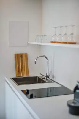 a kitchen with a sink in a white kitchen at Finesign 2 in Naturno