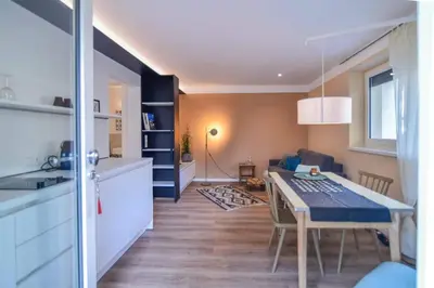 a kitchen and a dining room with a table in a room at Finesign 2 in Naturno
