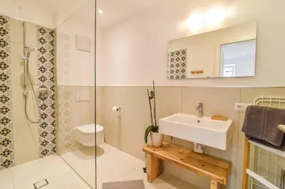 a bathroom with a sink and a toilet and a shower at Finesign 2 in Naturno