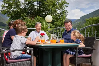 a group of people sitting at a table at Ferienpension Zummüllerhof in Naz-Sciaves