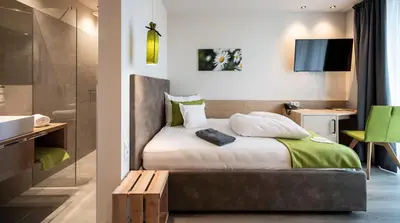 a hotel room with a bed and a desk at Hotel Pfeiss in Lana