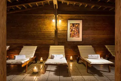 two beds in a room with candles and lights at Golfhotel Sonne in Siusi