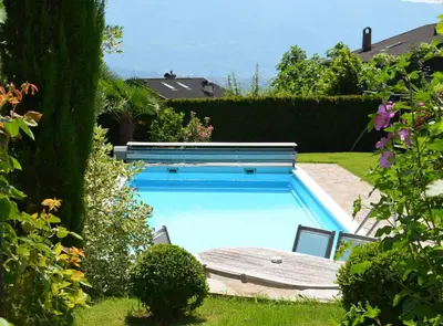 a swimming pool in a yard with some plants at Obermaratscher Apartments Residence in Lagundo