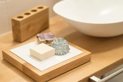 a wooden tray with soap and a bowl on a table at Art Apartment Schatzer in Funes