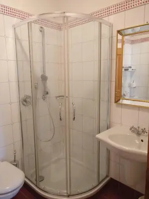 a bathroom with a shower and a sink at Schlosshotel Aehrental in Caldaro