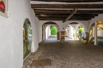 a hallway of a building with arches and a ceiling at Schlosshotel Aehrental in Caldaro