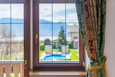 a window with a view of a yard at Schlosshotel Aehrental in Caldaro