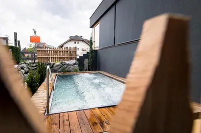 a small swimming pool on a wooden deck at Hotel Sonnenheim in Chienes