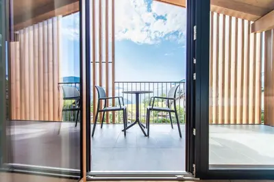 a balcony with a table and chairs on a balcony at Hotel Sonnenheim in Chienes