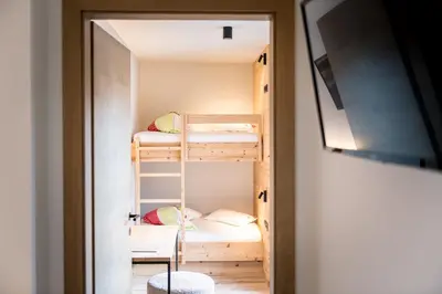 a small room with bunk beds in it at Hotel Sonnenheim in Chienes