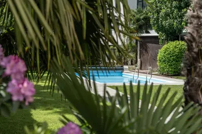 a swimming pool in a yard with plants at Residence Désirée Classic & Design in Merano